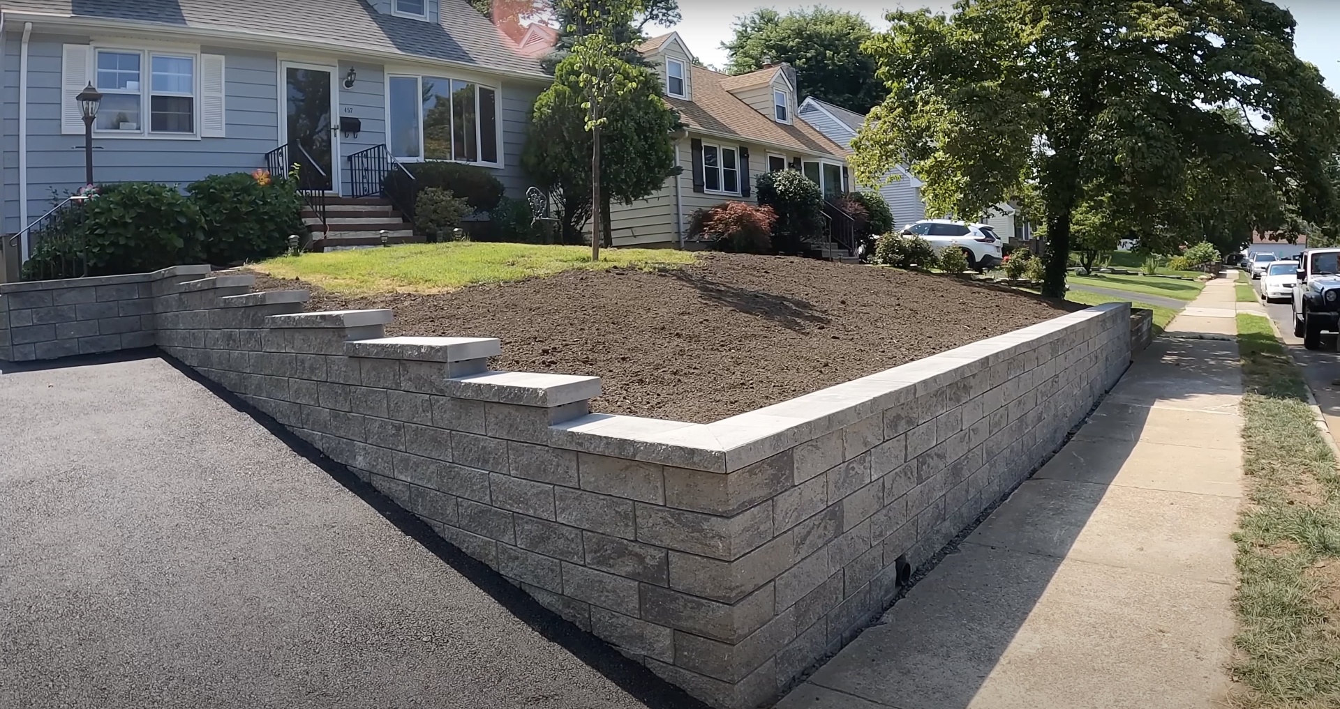 Completed concrete retaining wall project in residential neighborhood