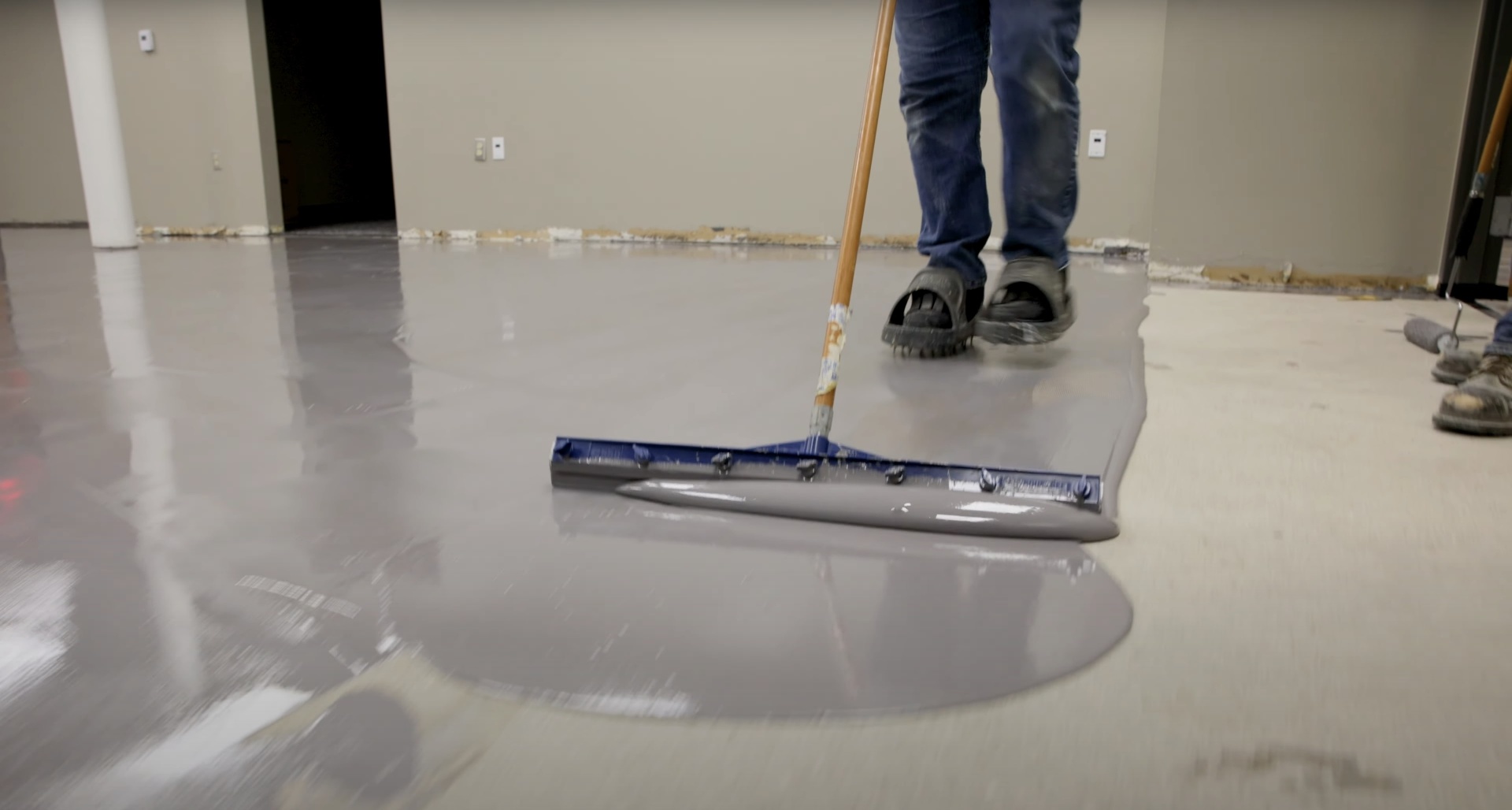 Smooth concrete floor finishing with professional squeegee equipment
